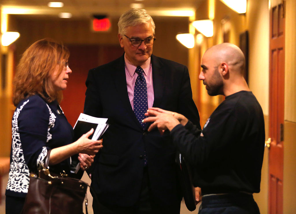 Stokes and Foley listen to an MU graduate student